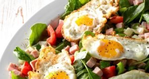 It’s not your typical breakfast, but it has all the right elements: easy, healthy and fast. Turn your favourite omelette ingredients into a morning salad! Ingredients 8 cups fresh baby spinach 1 cup chopped tomatoes 2 tablespoons olive oil, divided 1-1/2 cups chopped fully cooked ham 1 small onion, chopped 1 small green pepper, chopped 4 large eggs Salt and pepper to taste Directions * Arrange spinach and tomatoes on a platter; set aside. In a large skillet, heat 1 tablespoon olive oil over medium-high heat. Add ham, onion and green pepper; saute until ham is heated through and vegetables are tender 5-7 minutes. Spoon over spinach and tomatoes. * In the same skillet, heat remaining olive oil over medium heat. Break eggs, 1 at a time, into a small cup, then gently slide into skillet. Immediately reduce heat to low; season with salt and pepper. To prepare sunny-side-up eggs, cover the pan and cook until whites are completely set and yolks thicken but are not hard. Top salad with fried eggs. Nutrition Facts 1 serving: 229 calories, 14g fat (3g saturated fat), 217mg cholesterol, 756mg sodium, 7g carbohydrate (3g sugars, 2g fibre), 20g protein. Diabetic Exchanges: 3 lean meat, 2 fat, 1 vegetable. source - cooking365coza